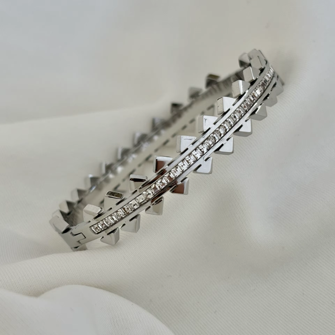 18K Silver plated no tarnish spiked and glass crystal bangle on a white background.