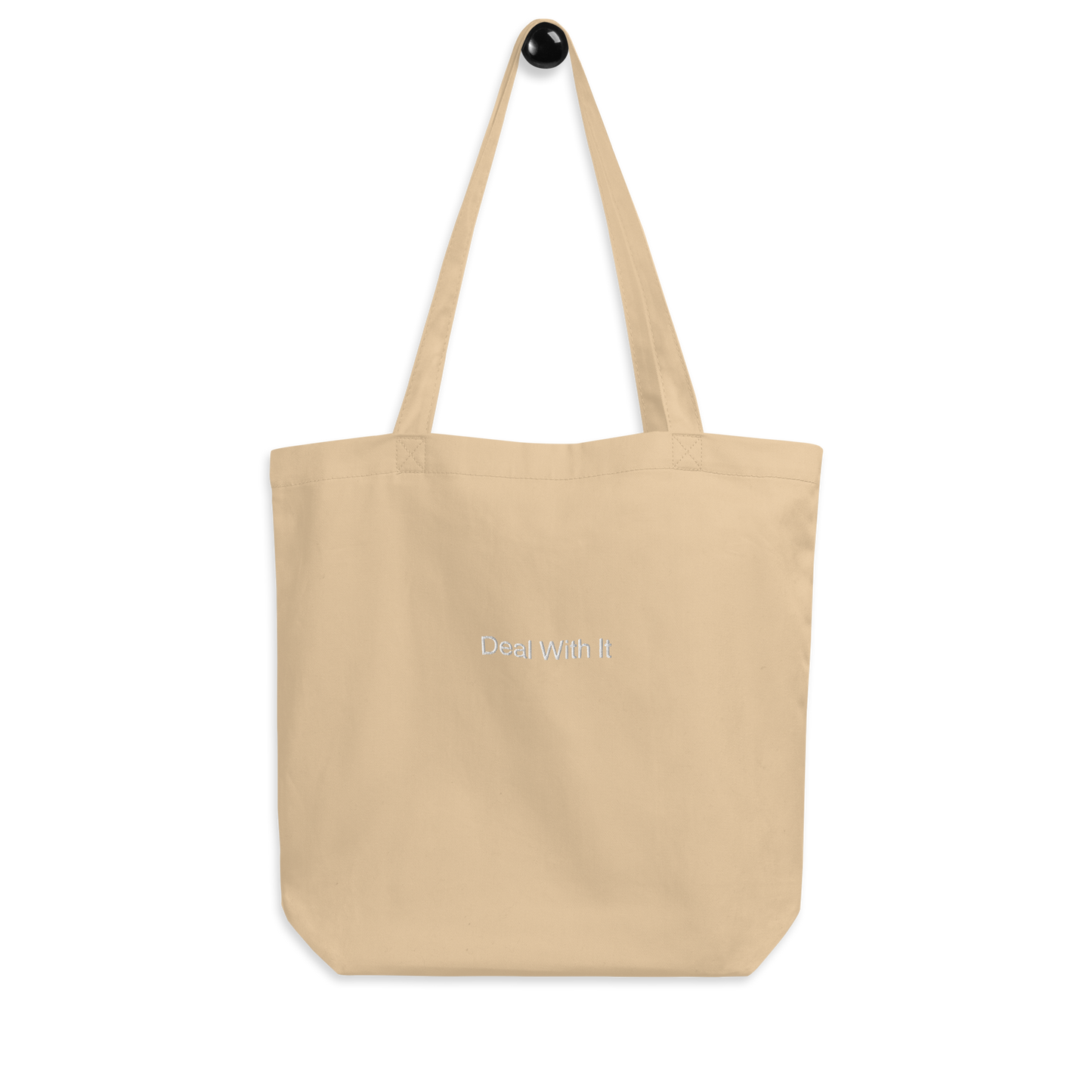 Beige Deal with It Slogan embroidered eco tote bag on a blank surface.