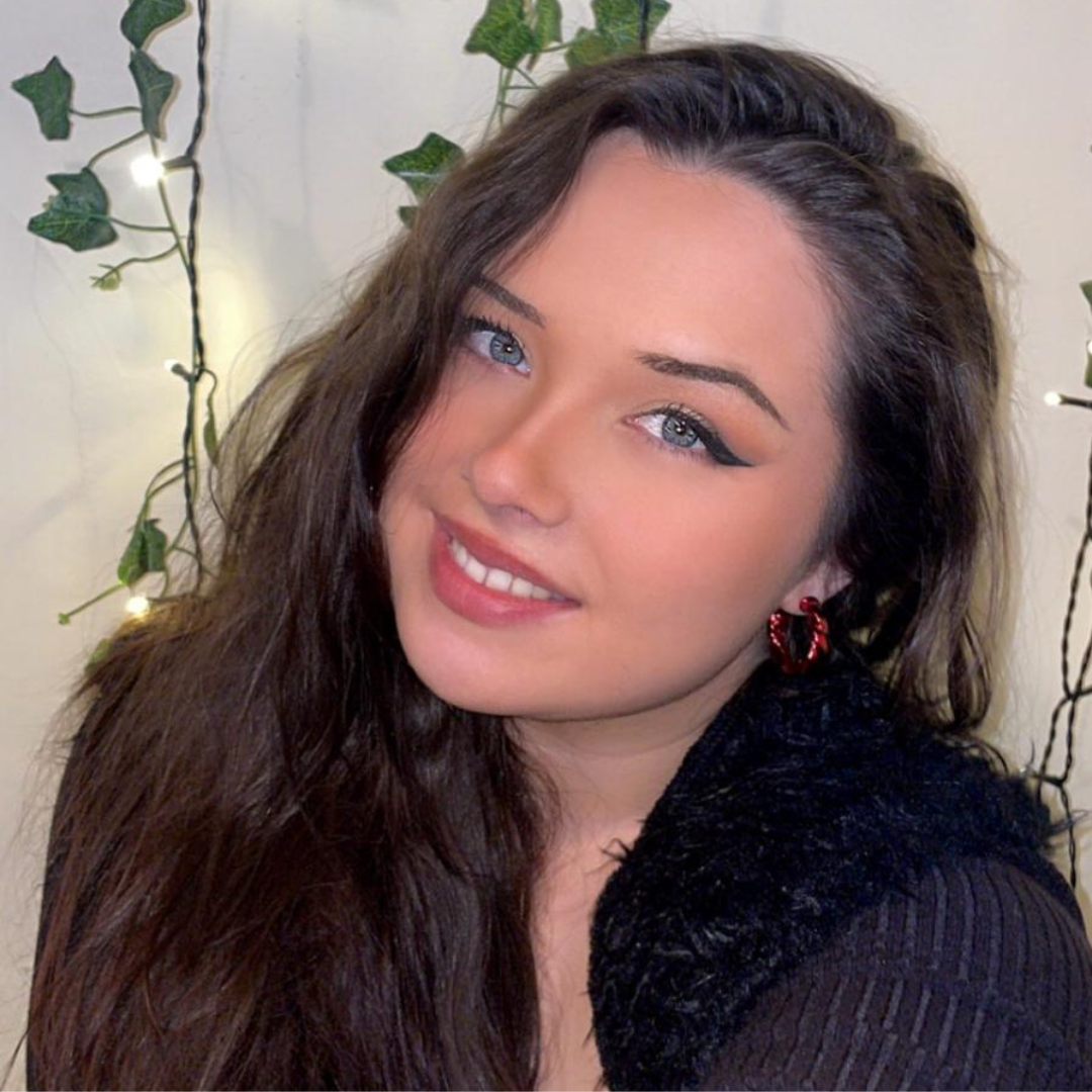 Fun neon bright acrylic hoops on a model smiling.