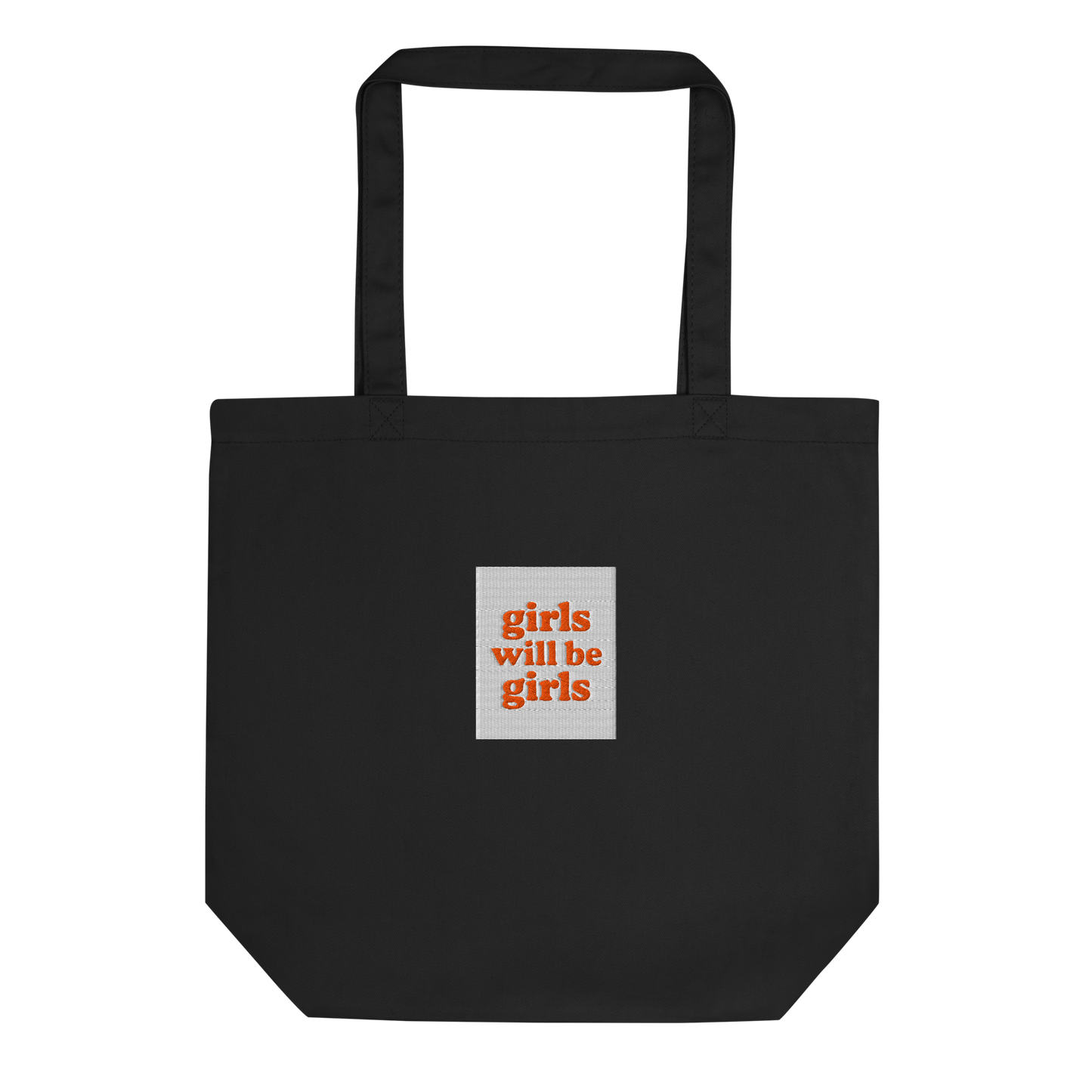 Black tote bag with a small embroidered square patch with the words girls will be girls on a white background.