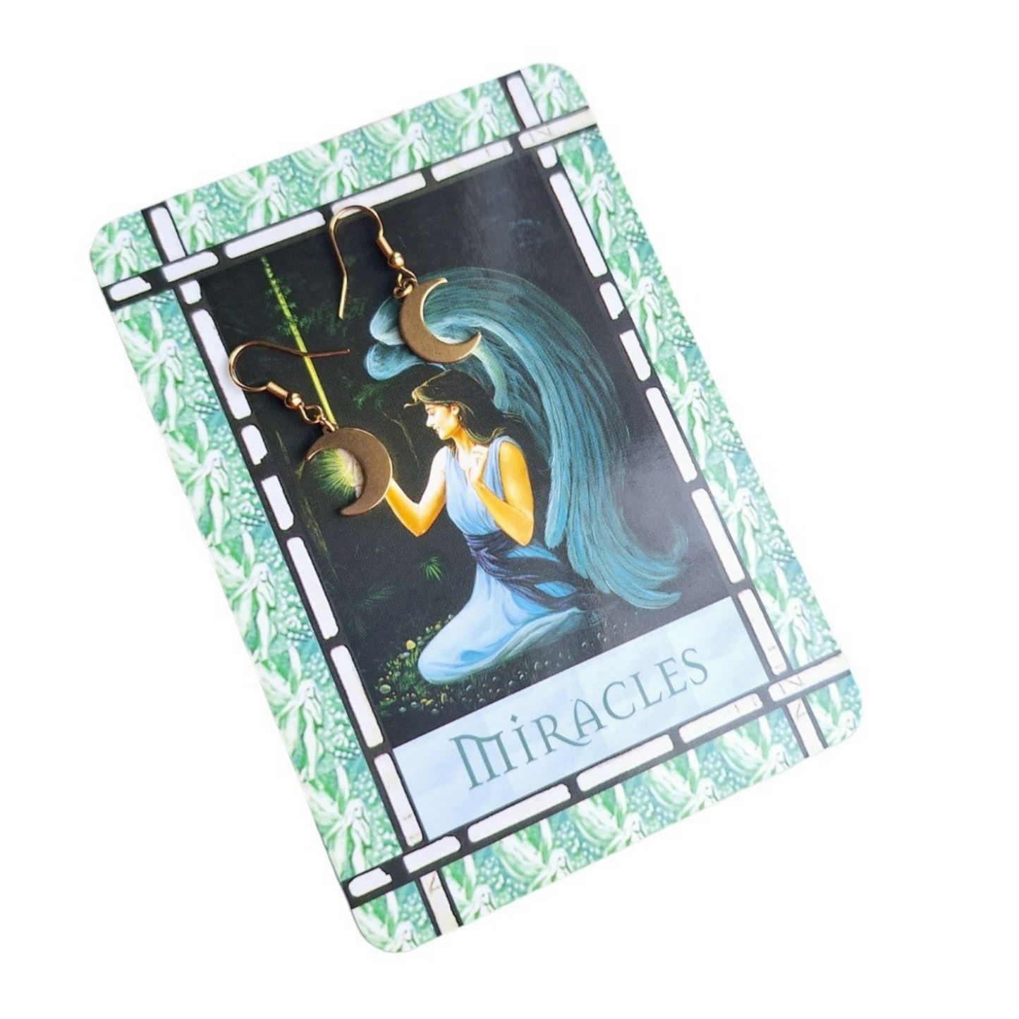 Celestial Moon Drop Gold Plated Earrings on a tarot card.