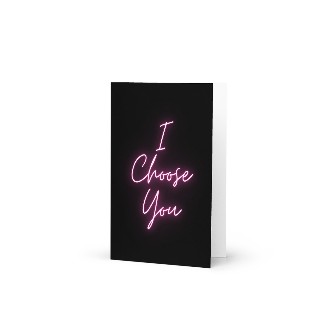 Greeting card with 'I Choose You' text in pink neon on a black background