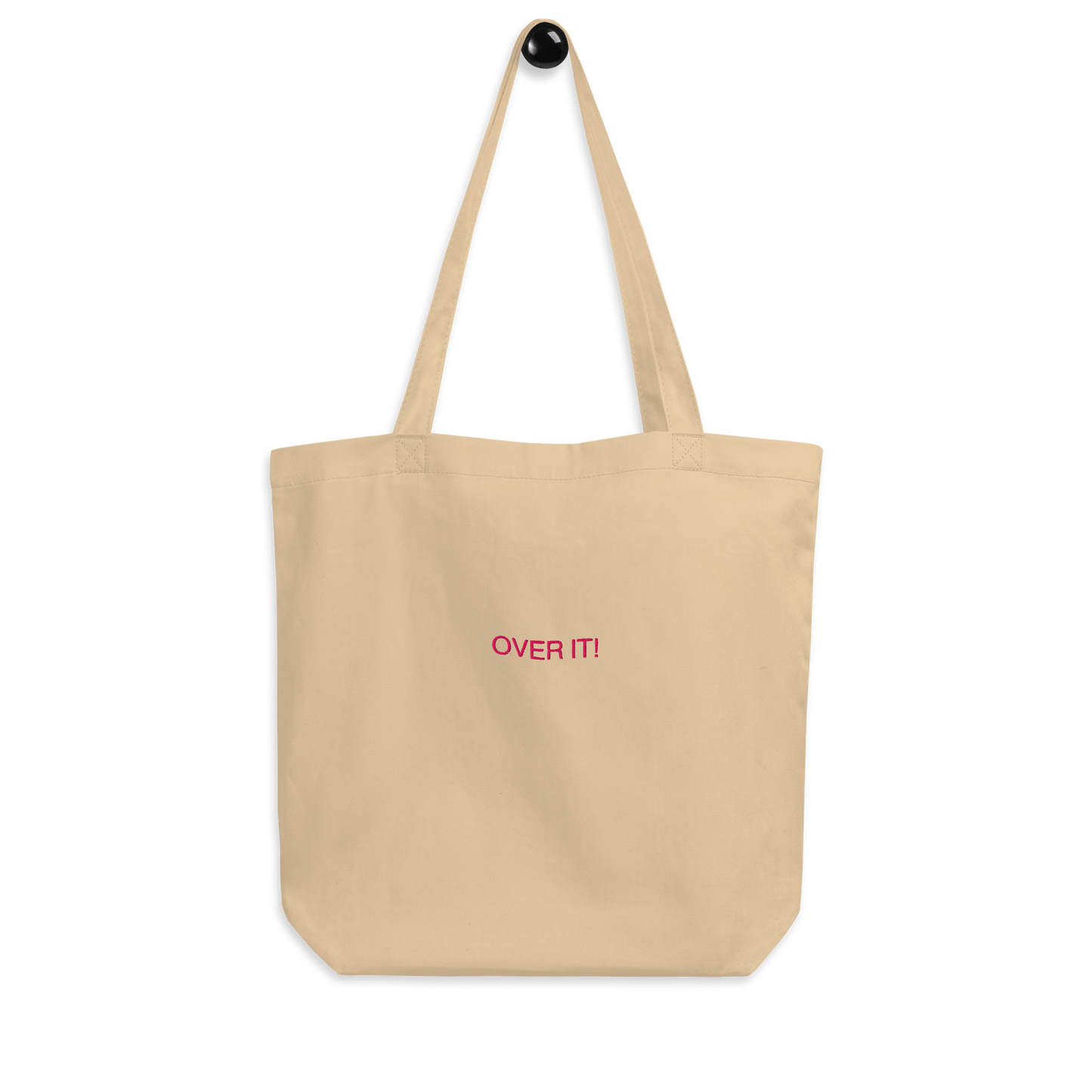 Over It slogan embroidered Eco Organic cotton tote bag on a blank surface.