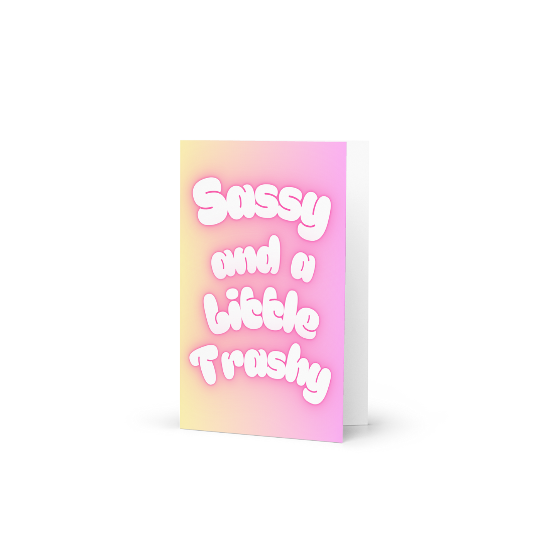 A funny card with the slogan Sassy and a little Trashy in bubble writing at the front in pastel colours.
