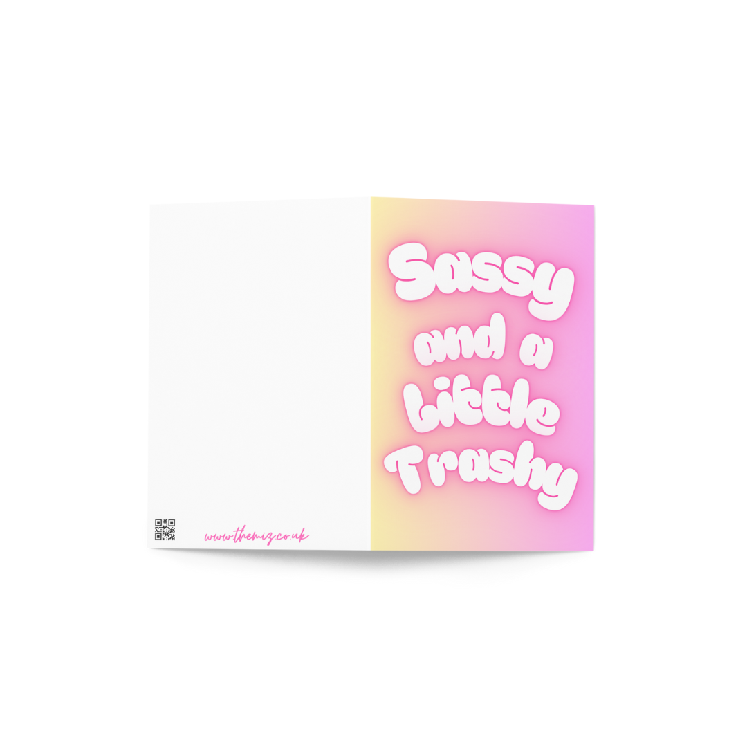 A funny card with the slogan Sassy and a little Trashy in bubble writing at the front in pastel colours.