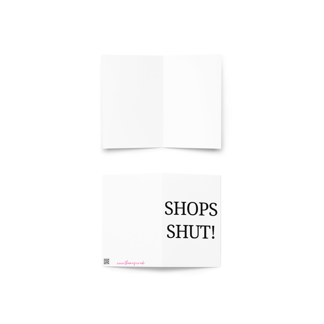 A white greeting card with the funny phrase Shops Shut! in black capital letters.
