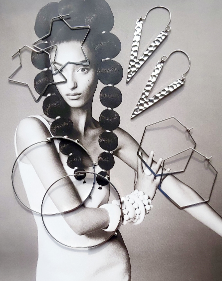 A pair of silver-plated, textured triangle earrings and other styles on a magazine cover.