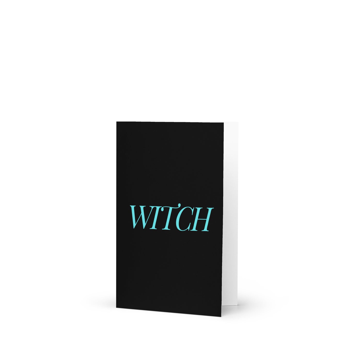 A funny witch greeting card on a white surface.