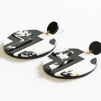 Upcycled Black and White Resin Drop Earrings on a white background.