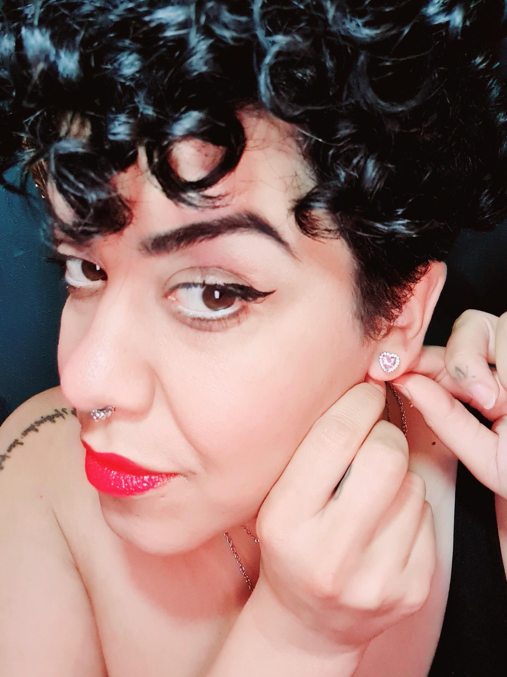 14k Plated pink stone Sweetheart Stud Earrings on a pretty girl with fabulous curly hair and red lips.