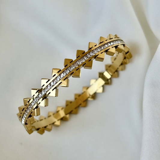 18K Gold no tarnish spiked and glass crystal bangle on a white background.