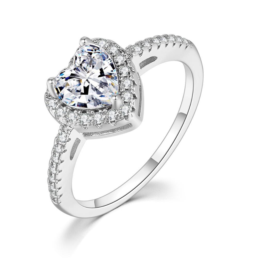 18k white gold plated sparkle heart ring with a glass cubic zirconia main stone on a white background.