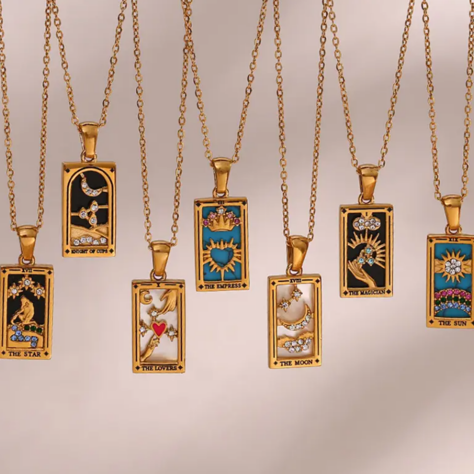 18K gold plated tarot card necklaces with a pendant  card designs and a chain extensions laid side by side.