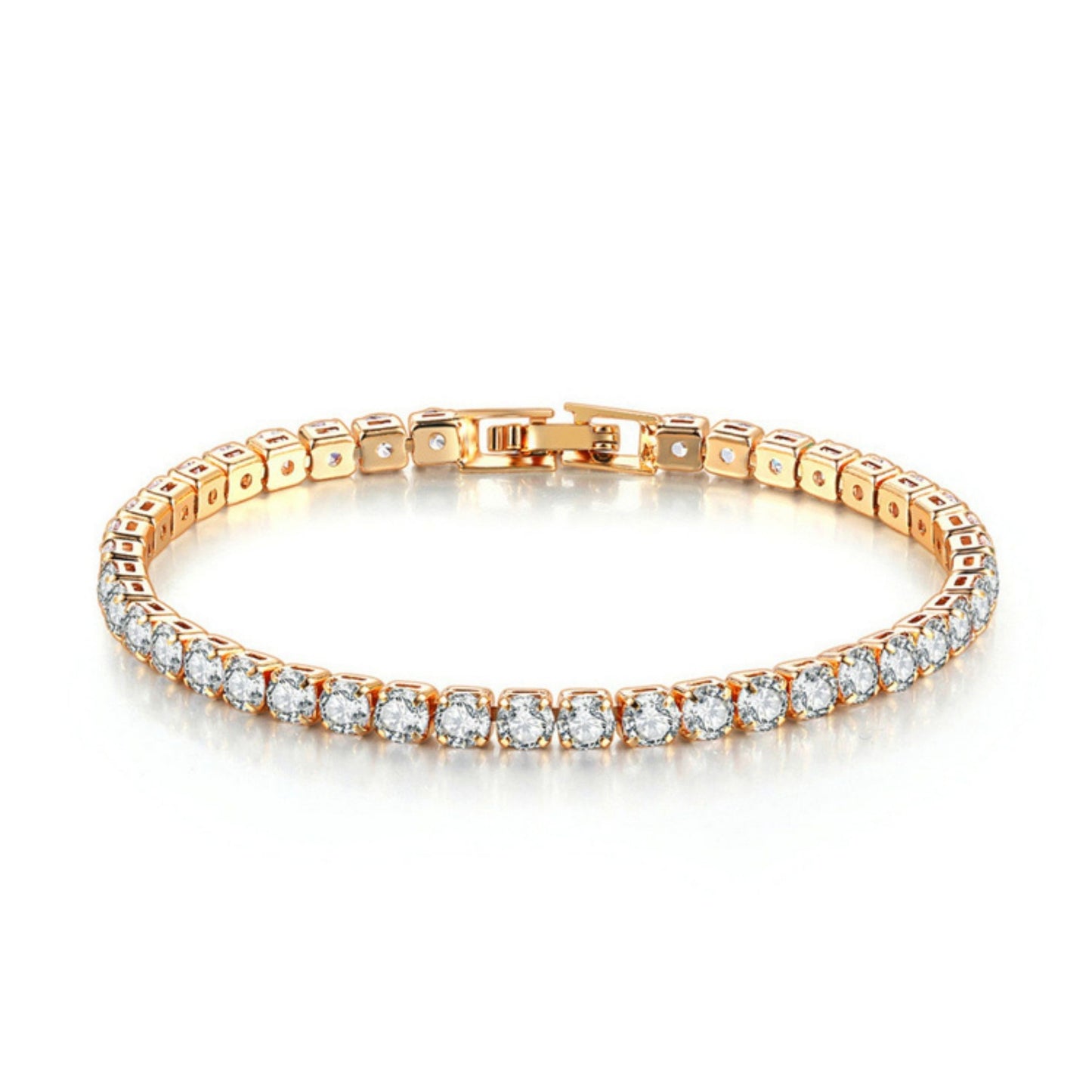 A gold-plated tennis bracelet with sparkling stones, laid out on a plain surface.