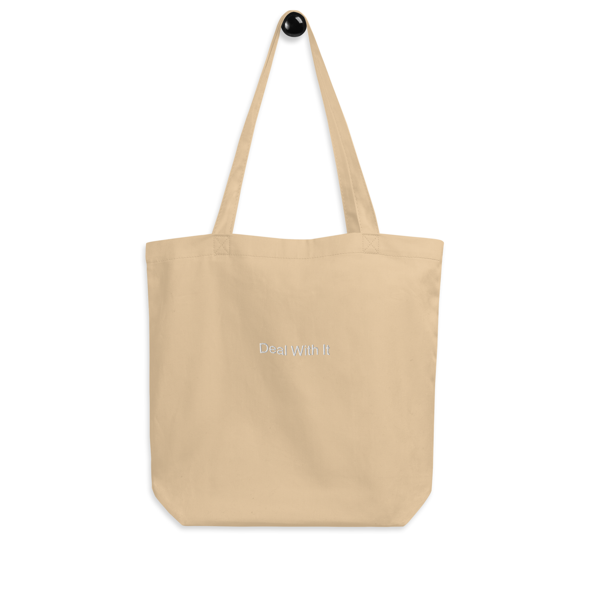 Beige Deal with It Slogan embroidered eco tote bag on a blank surface.