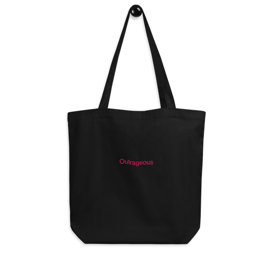 Black outrageous Slogan embroidered eco tote bag on a blank surface hanging on a hook.