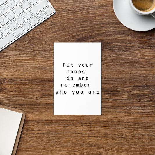 Female empowerment hoops greeting card on a office desk.