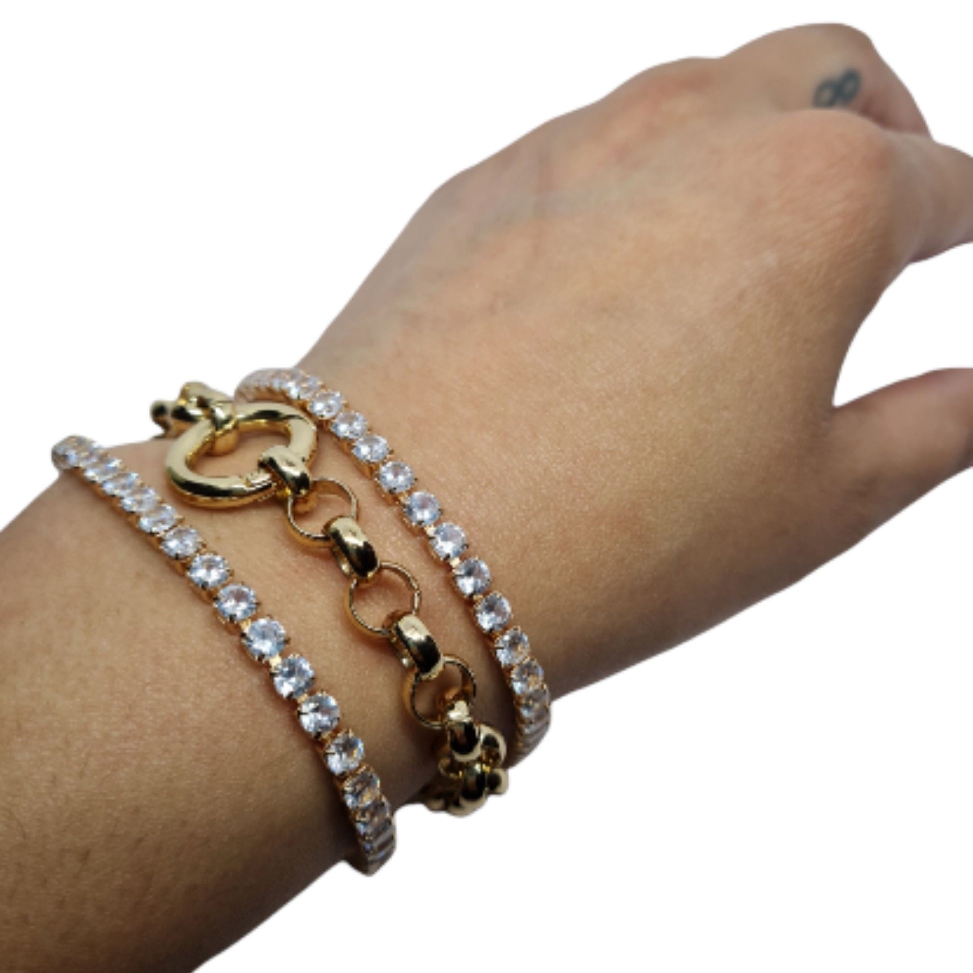 A gold-plated chunky Rollo chain bracelet with two sparkle bracelets on an arm on a white background.