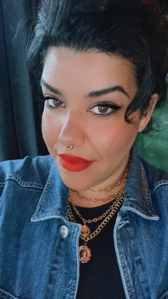 A gold-plated ,multi layer chunky coin necklace displayed on a pretty girl with a nose ring.