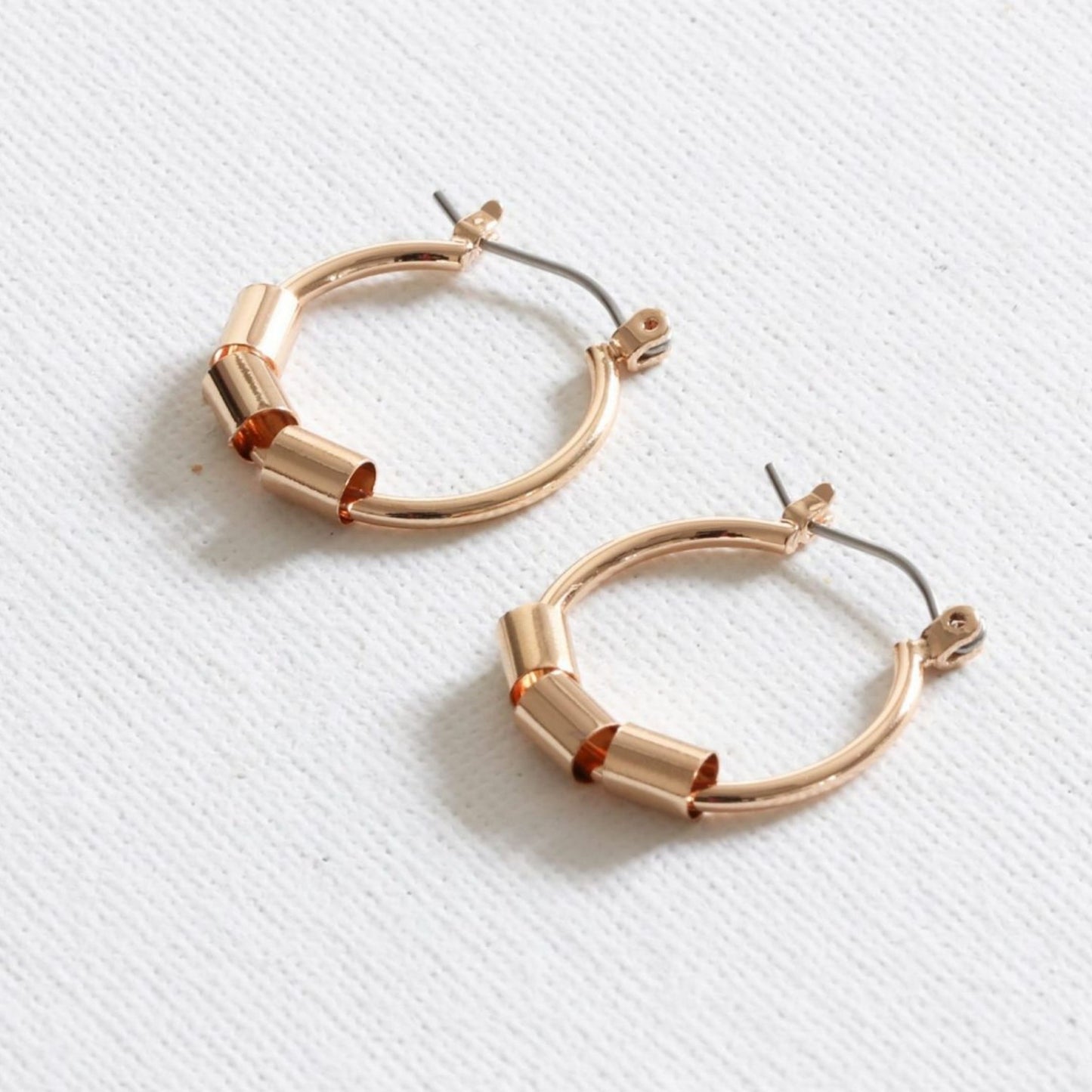 A pair of upcycled gold plated beaded hoop earrings on a white background.