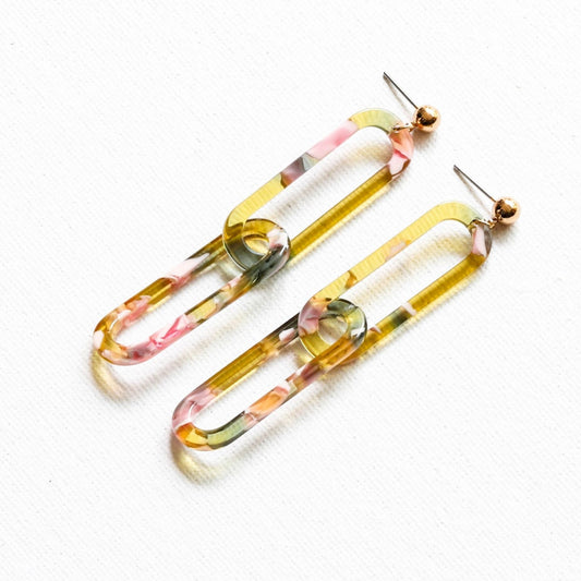 Recycled Summer Rose Link Resin Drop Earrings featuring a geometric rose-shaped design in a translucent yellow and pink resin with gold plating on a white background.