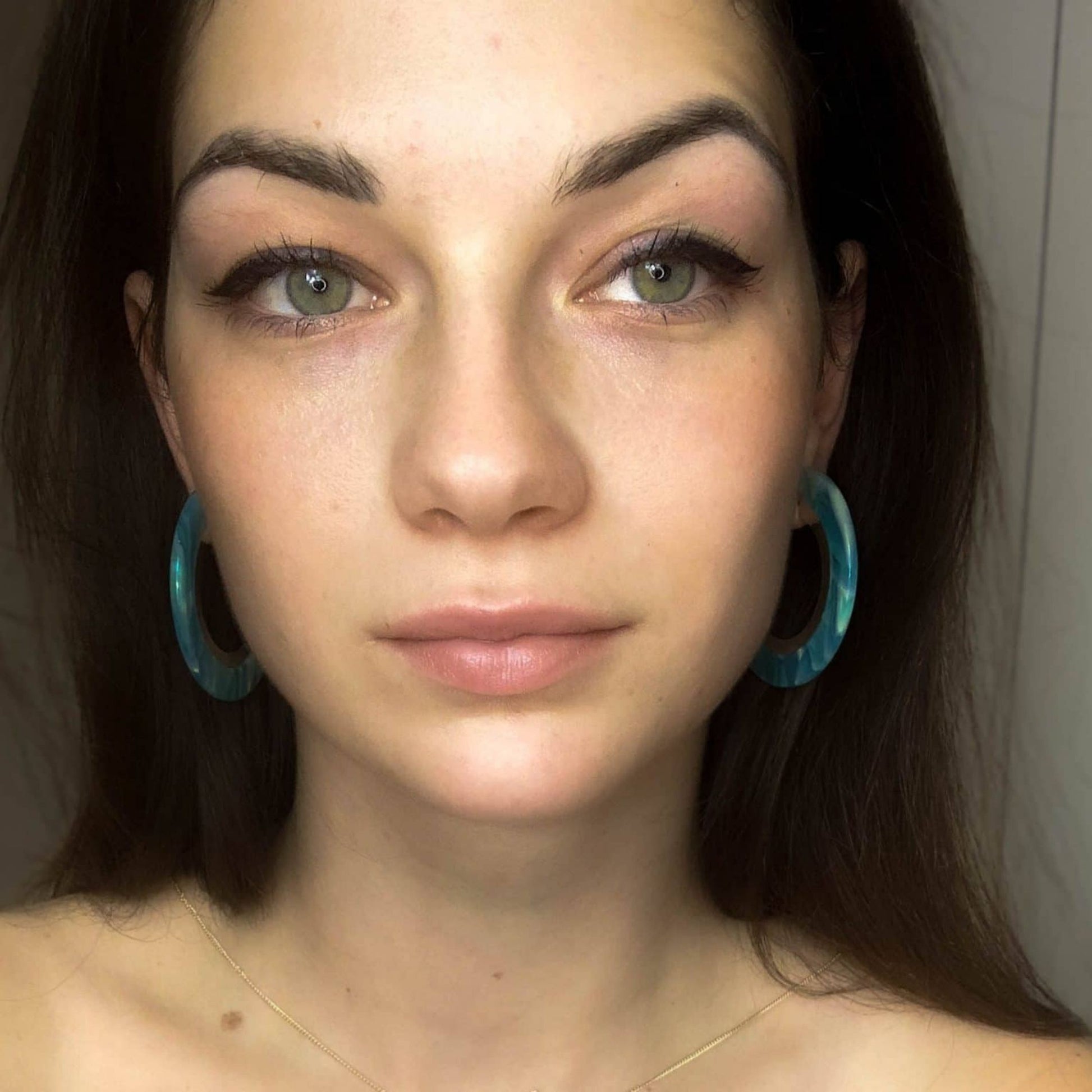 Recycled Under the Sea Resin Hoops on a pretty brunette.