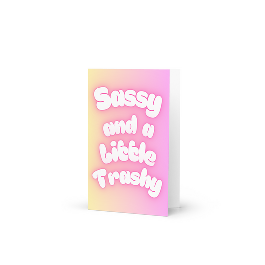 A funny card with the slogan Sassy and a little Trashy in bubble writing at the front in pastel colours.