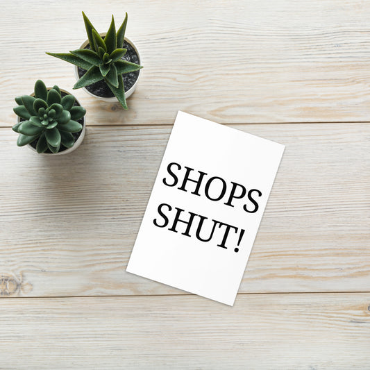 Funny Shops Shut Greeting Card on a wooden floor background with two green plants at the side.
