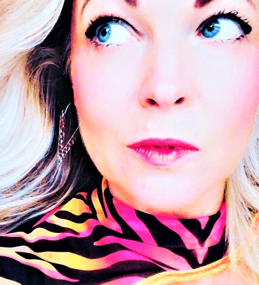 A pair of silver-plated, textured triangle earrings on a cool woman wearing 80's clothing.