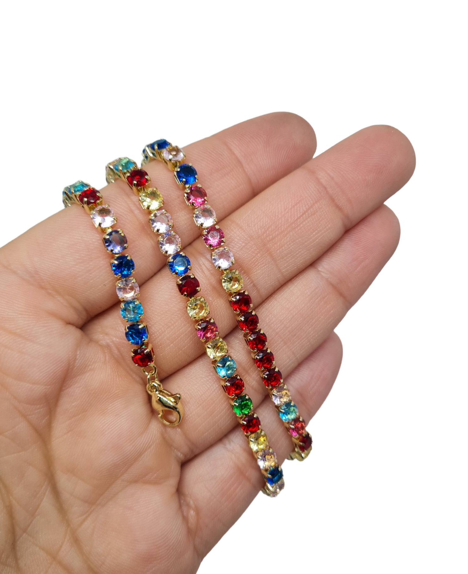 A rainbow stoned sparkle necklace wrapped around a hand on a white background.