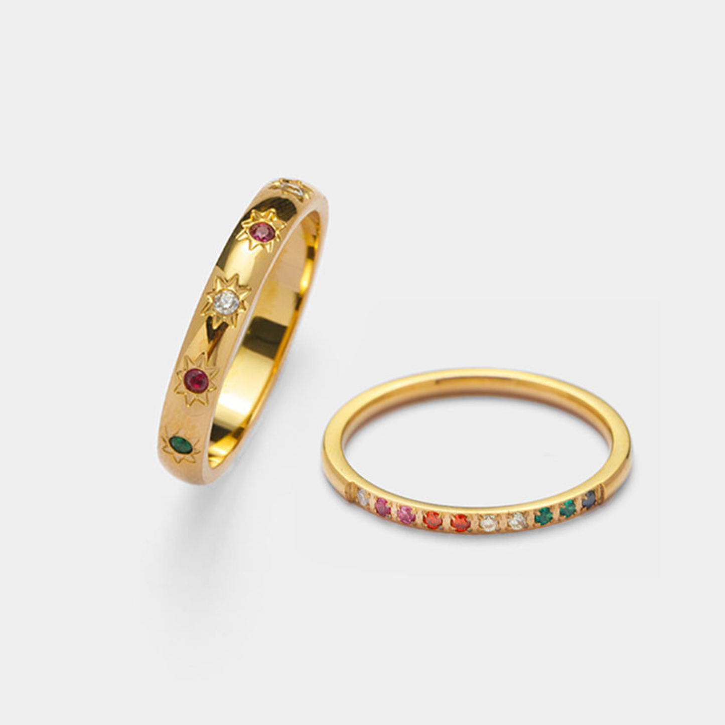Stainless Steel 18K Gold Plated Celestial Stone Ring and Stainless Steel 18K Gold Plated Rainbow band Stone Ring on a light gray background.
