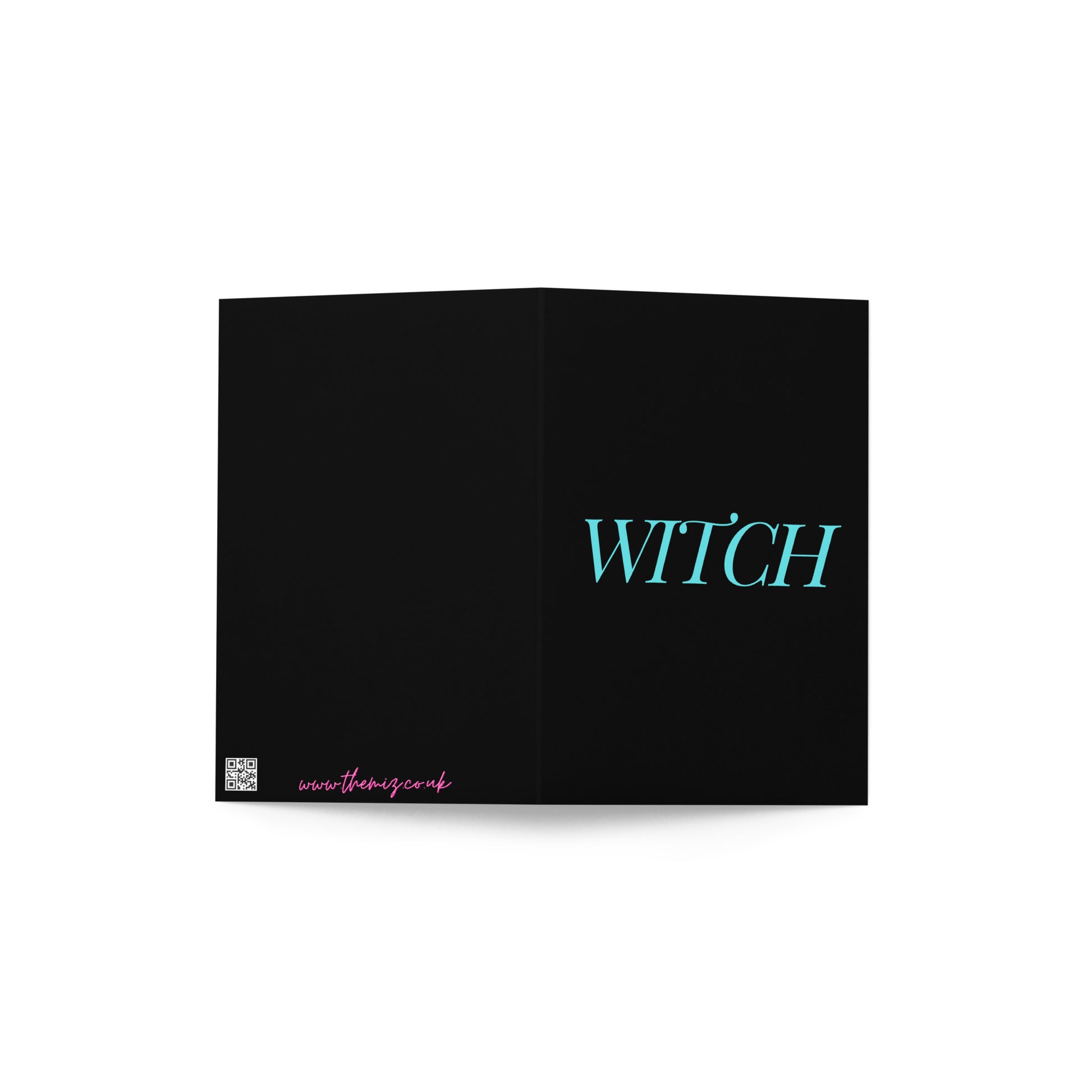 A funny witch greetings card on a white surface.