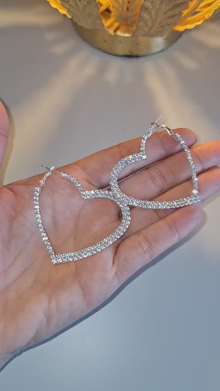 925 Silver Plated Sparkle heart hoops held in a hand so you can see the sparkle.